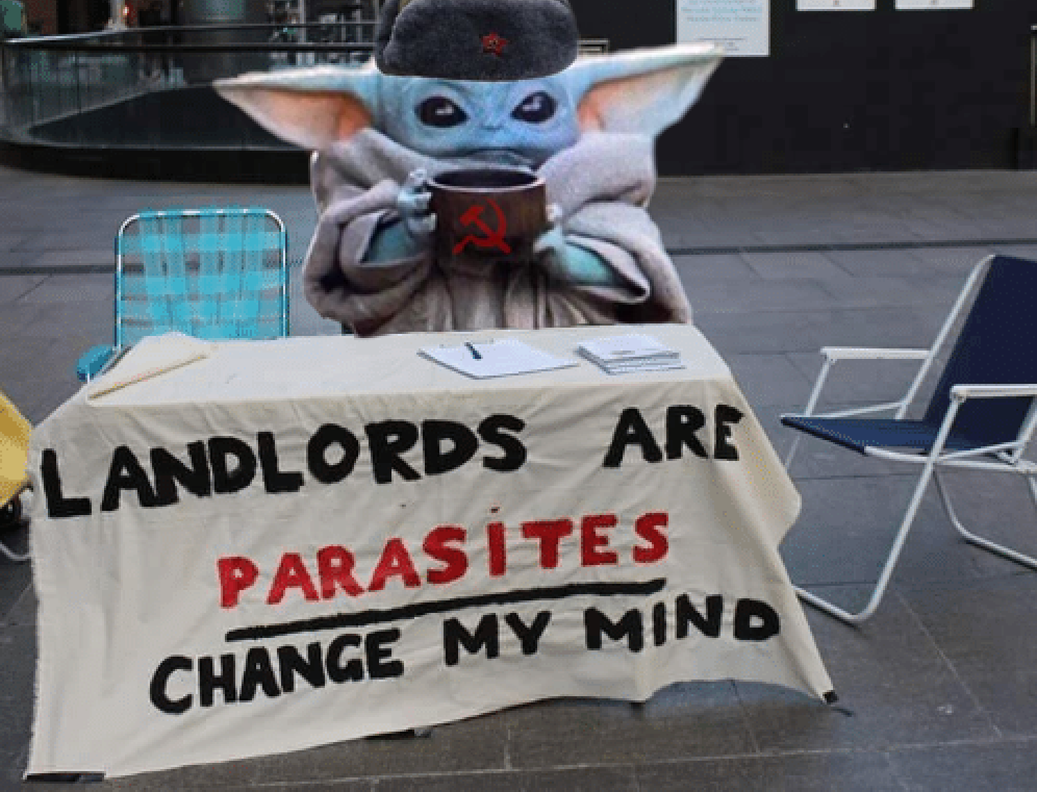 This meme is a humorous image of the character Baby Yoda from the Star Wars series sitting at a desk with a sign that reads "Landlords are parasites. Change my mind." The image is likely a commentary on the struggles of being a tenant and the frustrations that come with dealing with landlords.